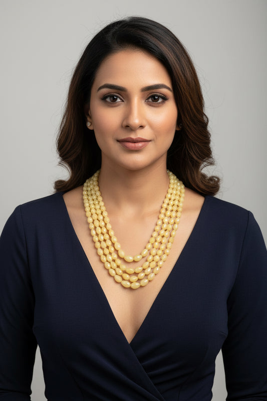 The Yellow Sapphire Briolette Pearl Shaped Necklace worn by a model, showcasing its elegance and rich color.
