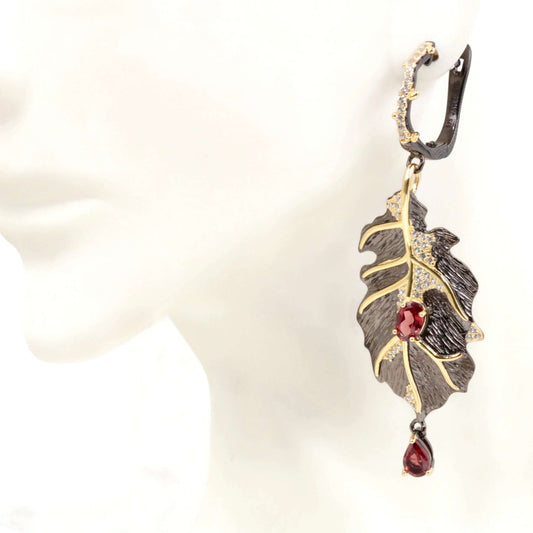 18K Gold Fill Natural Garnet Dangle Leaf 925 Silver Earrings displayed on a model's ear, showcasing elegant design and natural garnet.