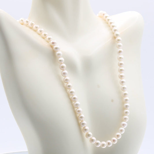 Fresh water pearl necklace displayed elegantly on a mannequin, highlighting its luster and classic design.
