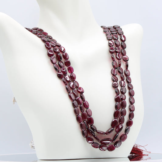 Rhodolite Garnet Smooth Polished Necklace displayed on a mannequin, showcasing its rose red and violet hues.