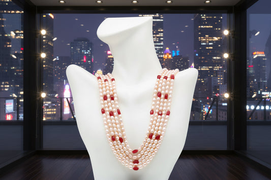 Fresh Water Pearl with Ruby Necklace displayed against a city skyline at night.
