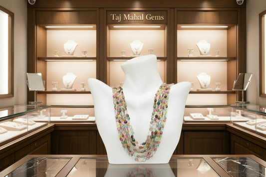 Tourmaline multi-color beaded necklace displayed in a jewelry store featuring elegant showcases.