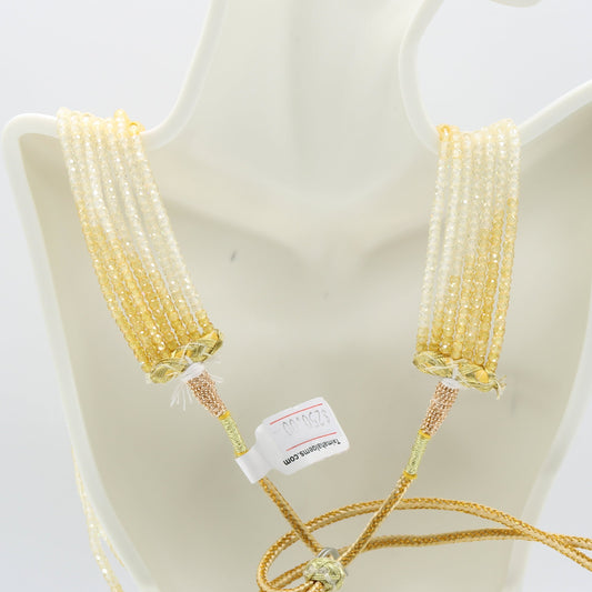 CZ Beaded Necklace with off white and yellow faceted roundelle beads, 7 strands, displayed on a mannequin.