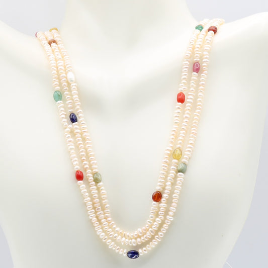 Fresh Water Pearl necklace featuring colorful Navratna gemstones on a display bust.
