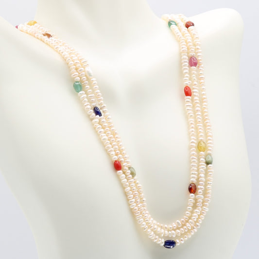 Fresh Water Pearl with colorful Navratna beads necklace displayed on a mannequin, symbolizing purity and elegance.