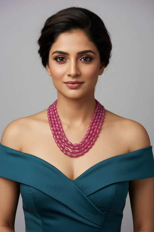 Model wearing The Pink Sapphire Faceted Necklace, showcasing its elegance and vibrant color.