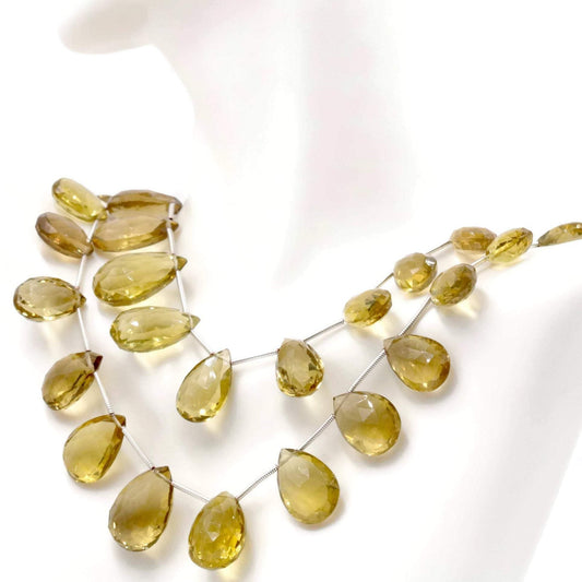 Natural lemon quartz beads in briolette cut, showcasing a beautiful yellow color ideal for jewelry making.