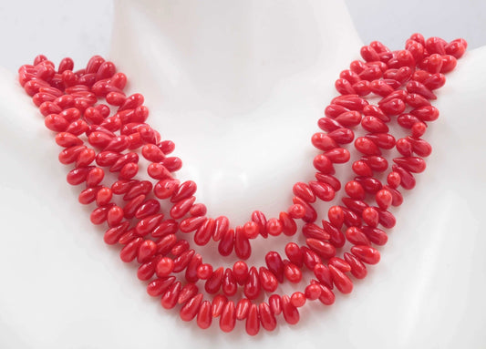 Natural Red Coral Drops Beads Strands displayed on a mannequin's neck, showcasing organic beauty and vibrant color.