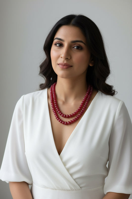 Natural Red Ruby Beads Necklace displayed elegantly on a white bust, showcasing its vibrant red color and unique design.