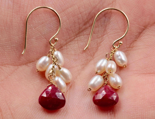 14k gold ruby pearl earrings featuring red faceted briolette and white freshwater pearls on a gold hook.