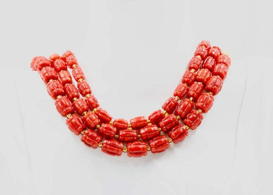 Italian red coral beads strand necklace showcasing vibrant red colors and ornate design.