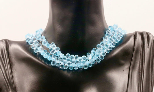 Natural Blue Topaz Beads necklace displayed on a mannequin bust, showcasing its vibrant blue color and unique texture.