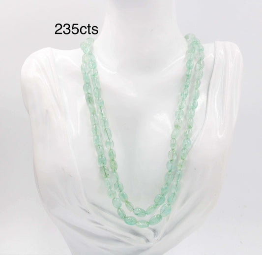 Natural Green Emerald Oval Bead Necklace on display, showcasing multiple strands of beautiful emerald beads.