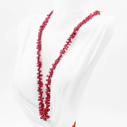 Natural ruby beaded necklace featuring vibrant red ruby gemstones on a stylish display.