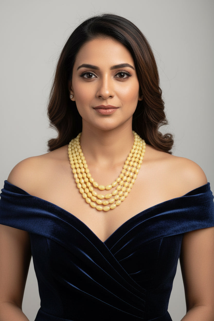 The Yellow Sapphire Briolette Pearl Shaped Necklace worn by a model, showcasing its elegance and rich color.