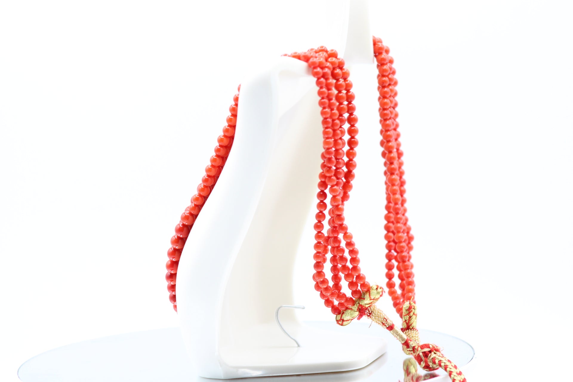 Natural Coral Necklace 4-6mm displayed on a mannequin showcasing its vibrant color and multiple strands.