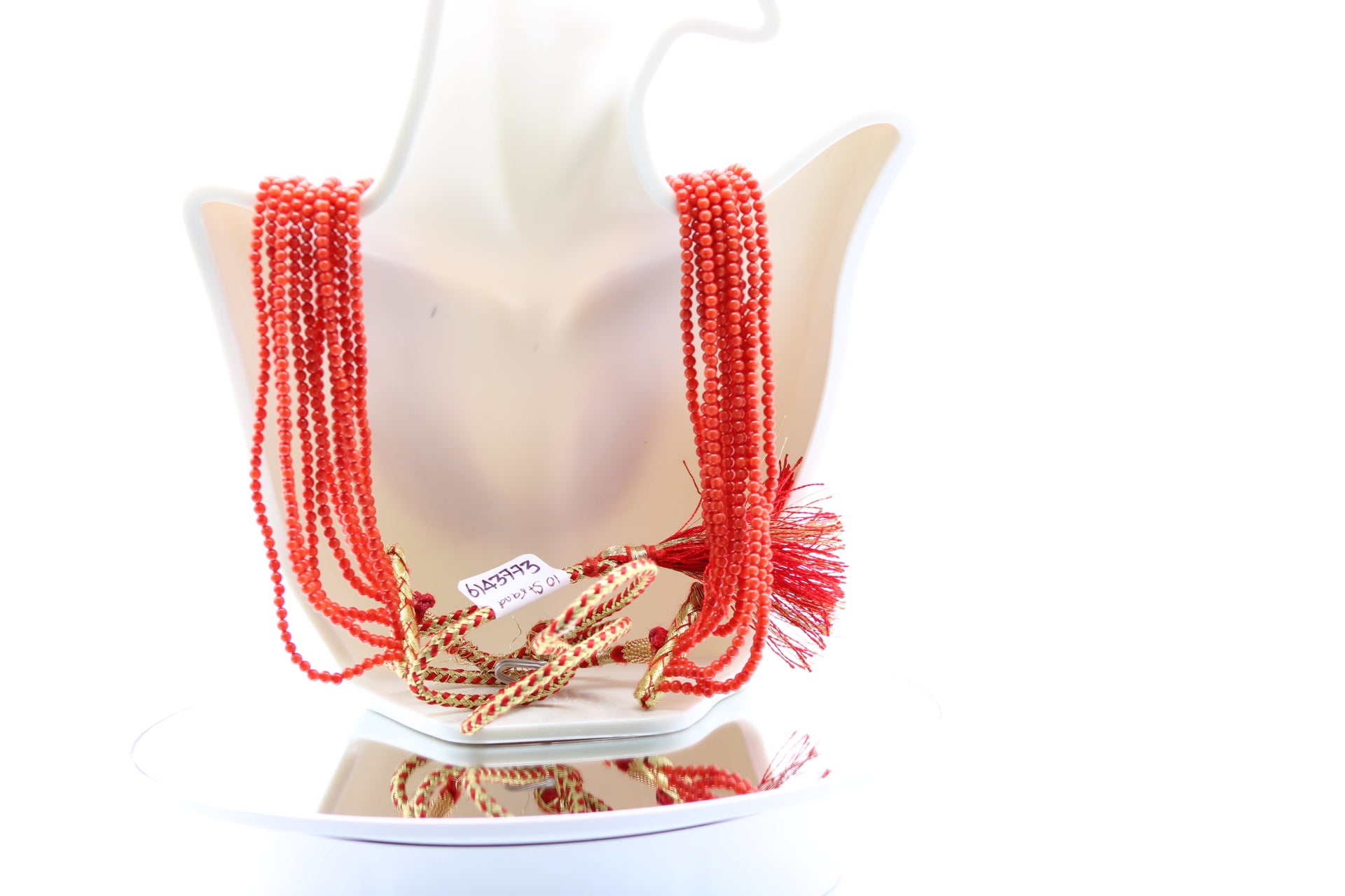 Coral Necklace 3mm - 10 Strands displayed on a mannequin showcasing its reddish orange color and polished finish.
