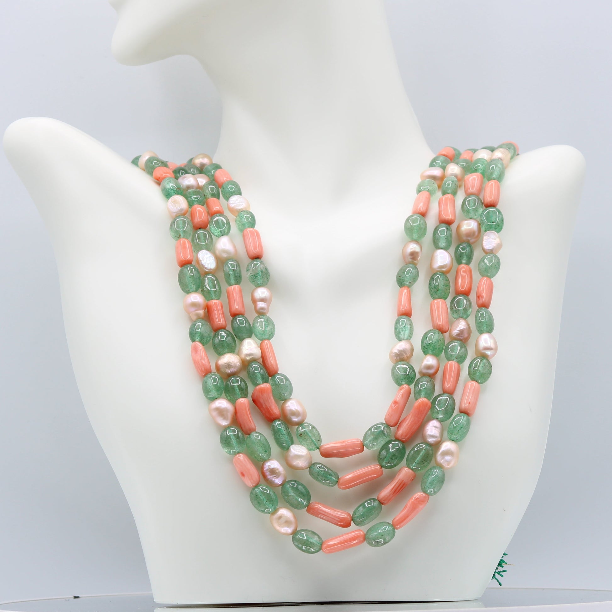 Russian Emerald with FWP and Coral Layered Necklace displayed on a mannequin bust.