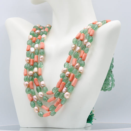 Russian Emerald with FWP and coral layered necklace on display, highlighting the stunning gemstones and pearls.