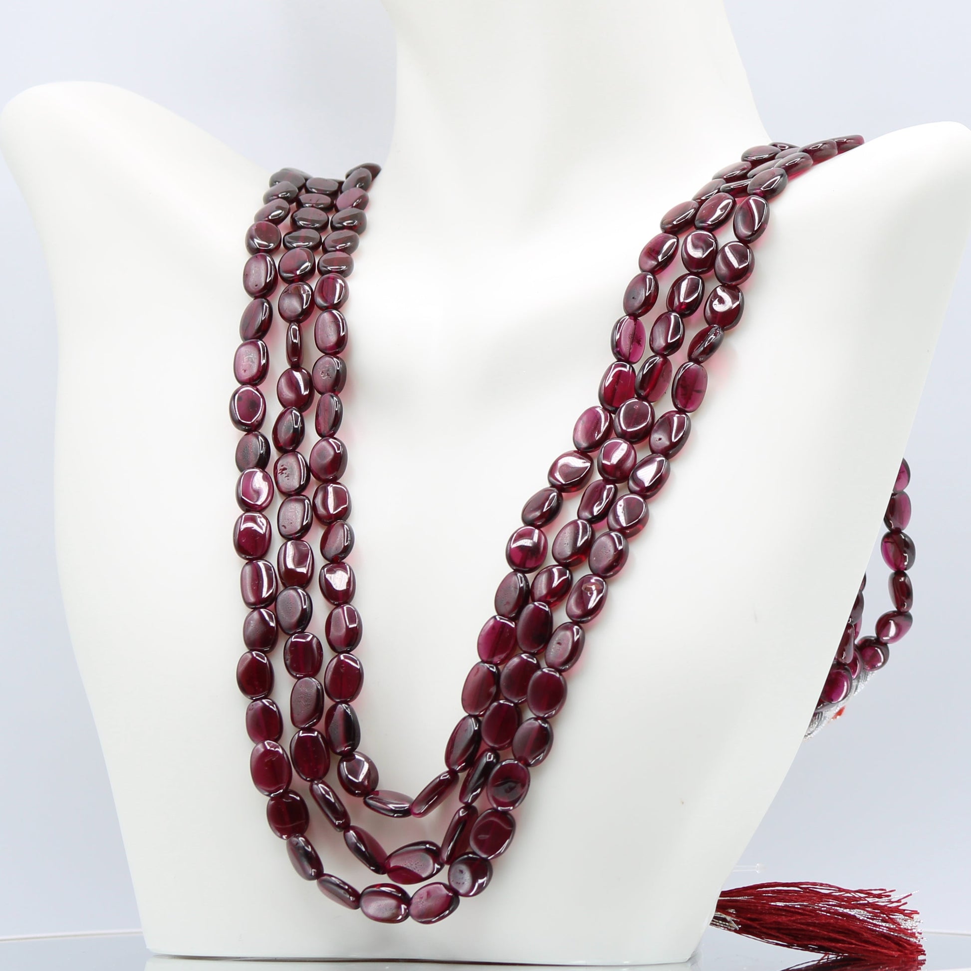 Rhodolite Garnet Smooth Polished Necklace displayed elegantly on a bust mannequin.