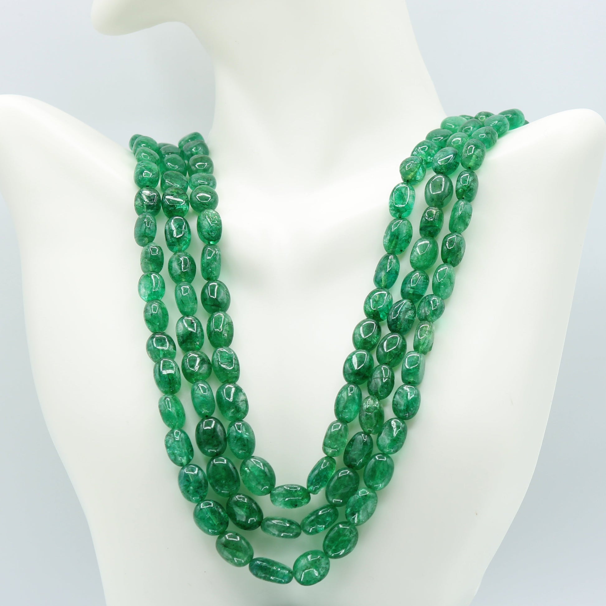 Emerald oval beaded necklace with 3 and 4 strands, showcasing green polished beads, lengths of 18-22 inches.