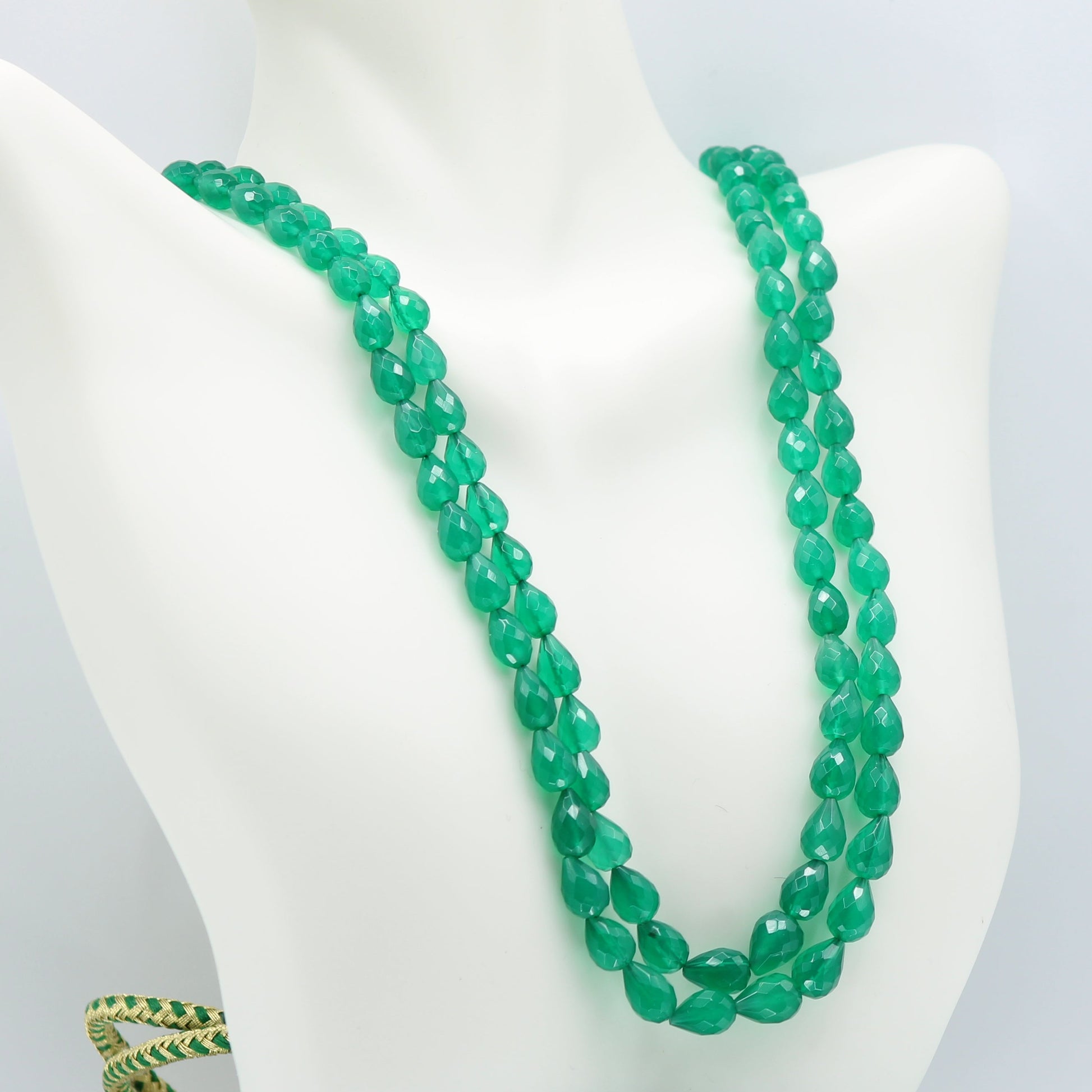 Emerald Pear Shape Faceted Necklace displayed on a mannequin, featuring green semi-transparent gemstones.