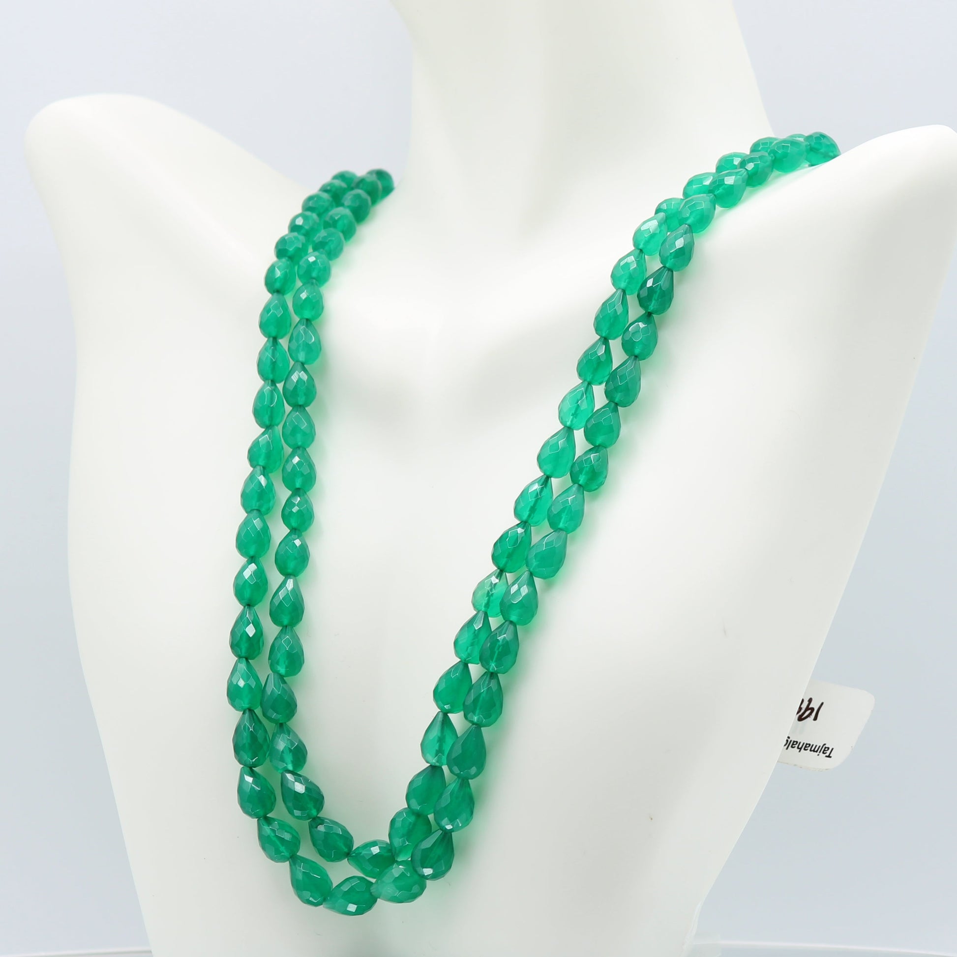 Emerald Pear Shape Faceted Necklace displayed on a mannequin, featuring green semi-transparent gemstones.