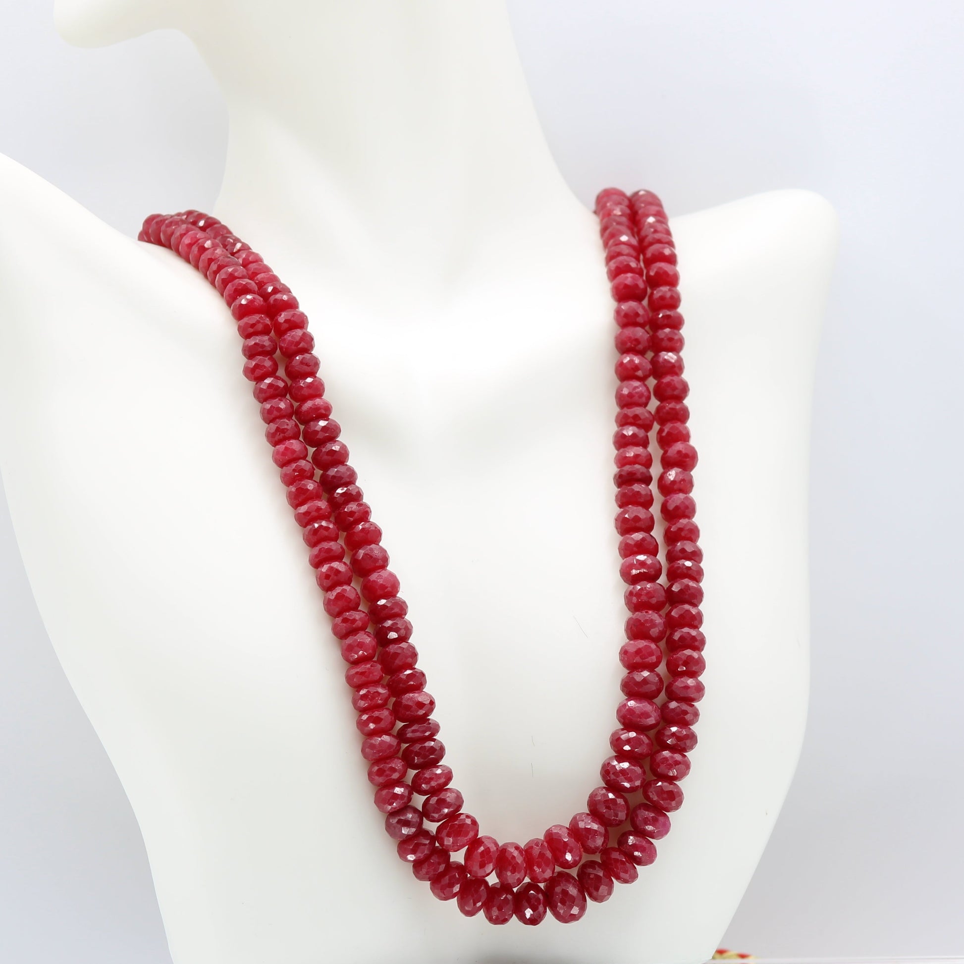Ruby Necklace Faceted Beaded - Multi Strand featuring natural red ruby gemstones on display.