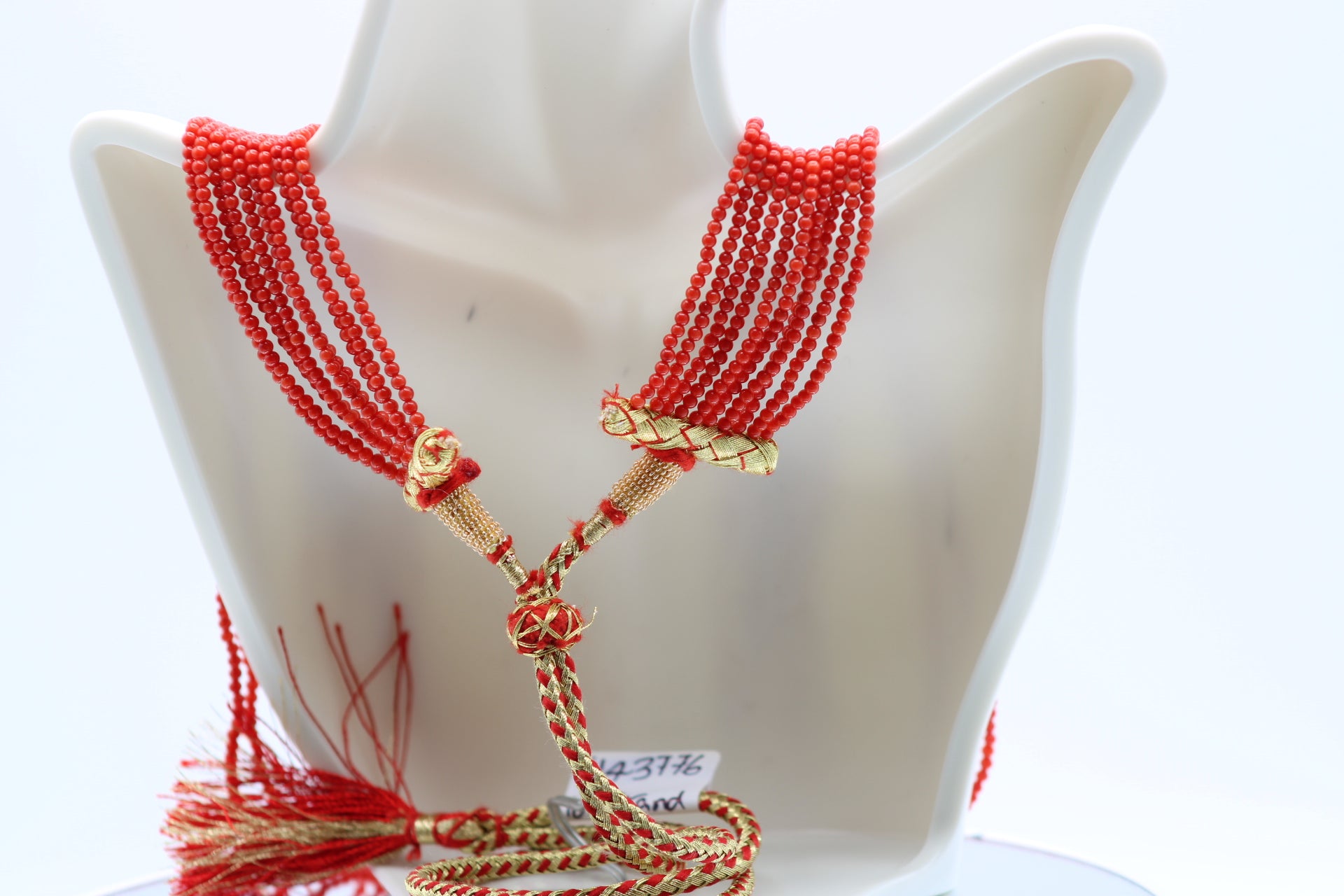 Elegant coral necklace 2mm showcasing polished coral beads in reddish orange hue, perfect for layering.