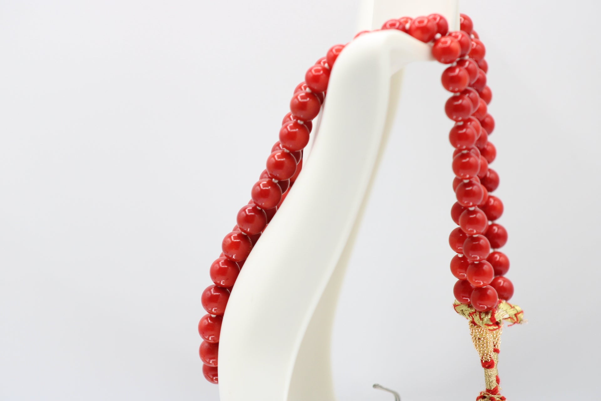 Natural orange coral gemstone necklace 8-10mm displayed on a mannequin.