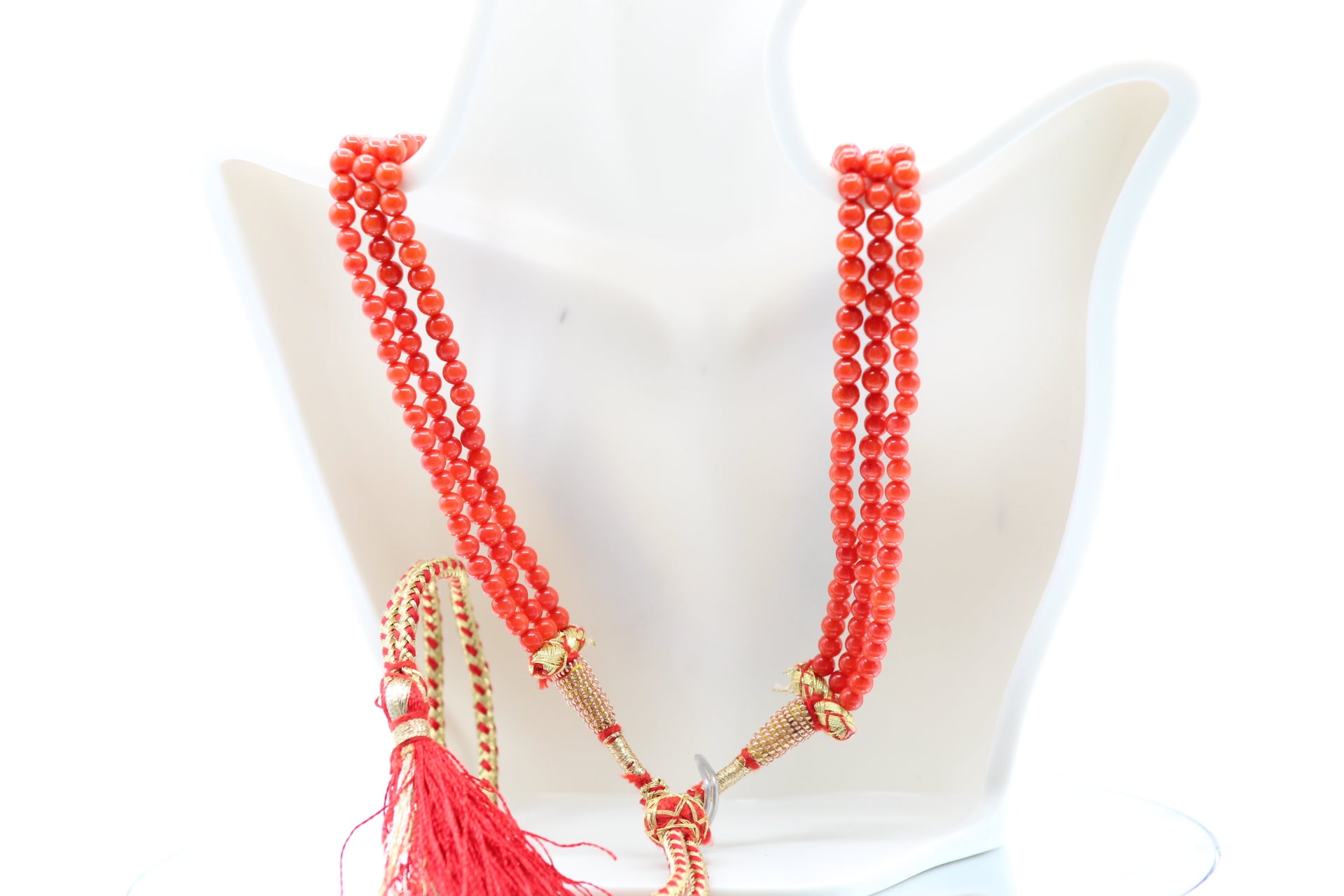 Natural Coral Necklace 4-6mm featuring five strands of vibrant coral beads and decorative tassel.