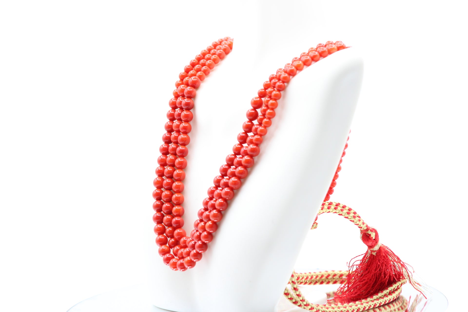Natural Coral Necklace 4-6mm - 5 strands of vibrant coral beads displayed on a mannequin.