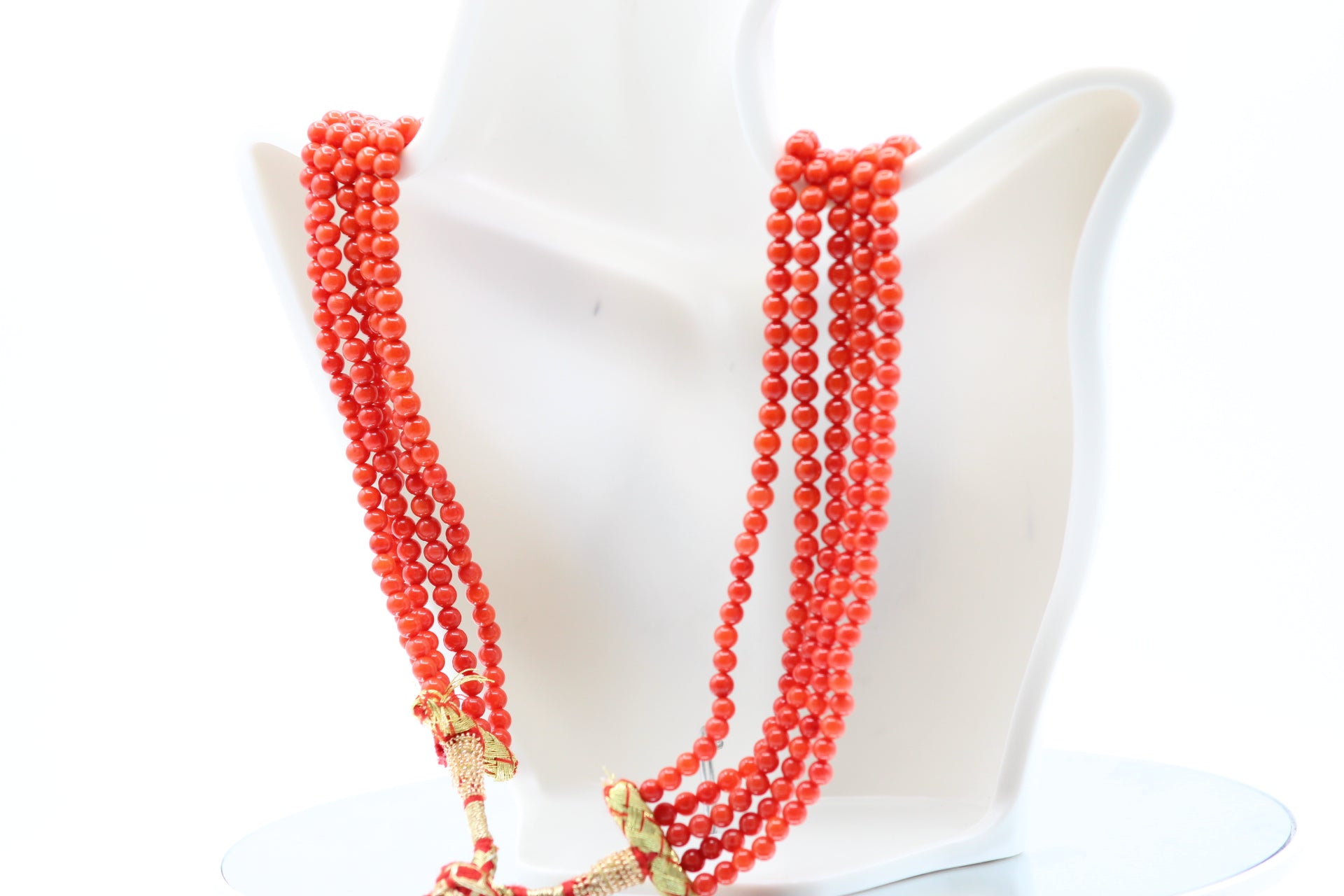 Natural Coral Necklace 4-6mm - 5 Strands displayed on a white bust, showcasing vibrant coral beads.