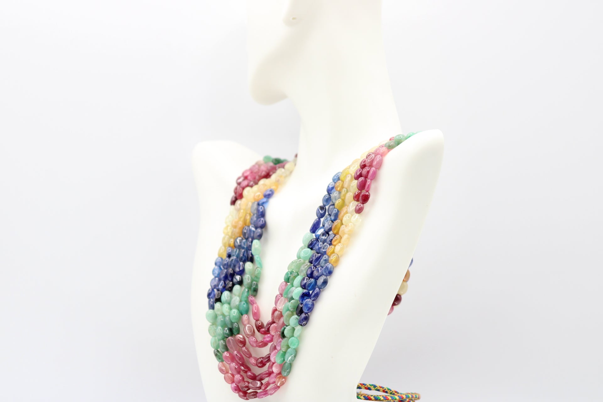 Multi Color Sapphire & Emerald Necklace displayed elegantly on a mannequin with vibrant hues of sapphires and emeralds.