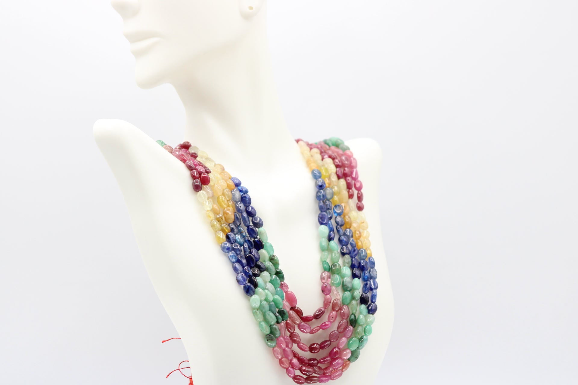Multi Color Sapphire & Emerald Necklace displayed on a mannequin showcasing vibrant gemstones and intricate design.