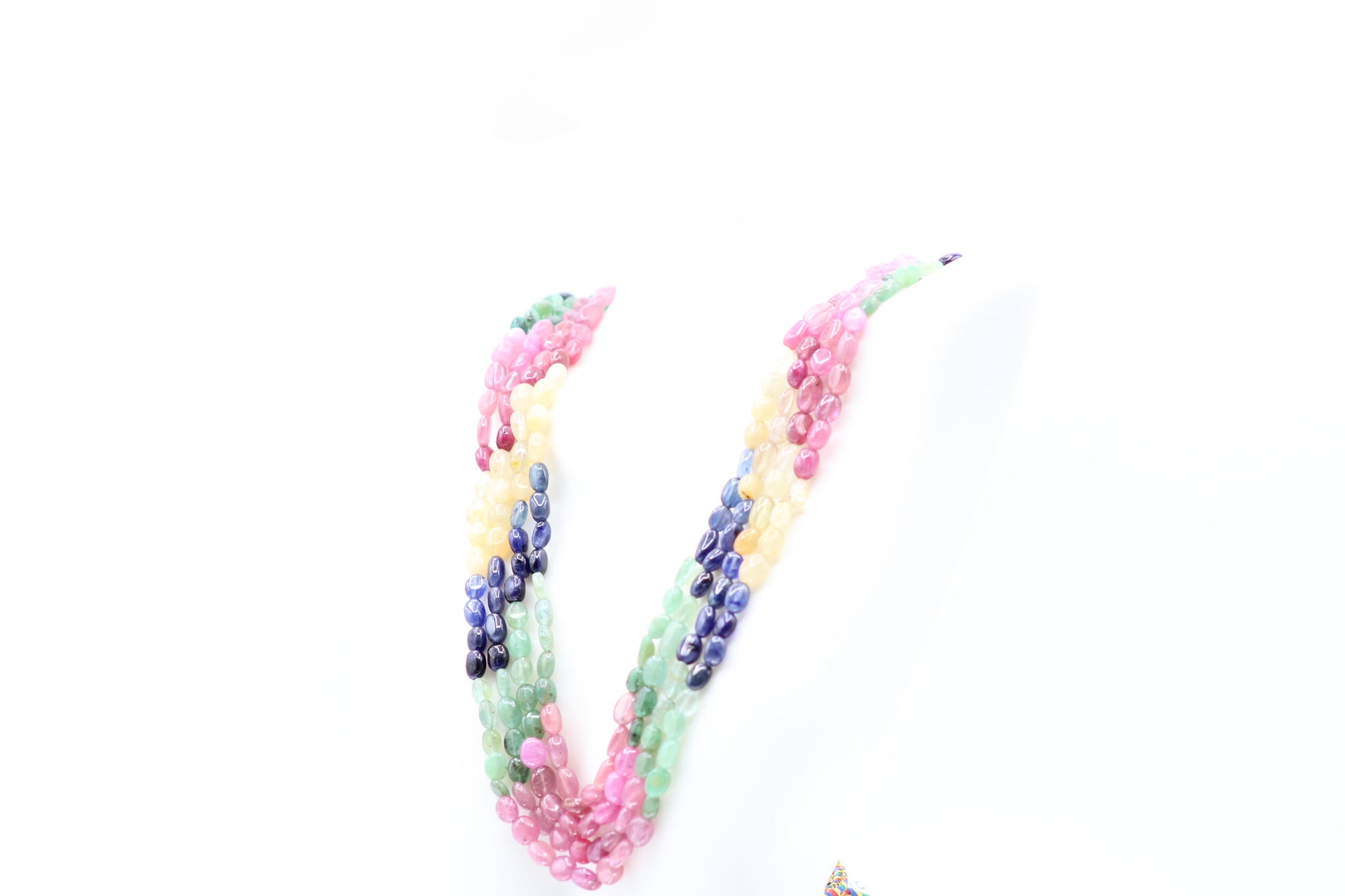 Multi Color Sapphire & Emerald Necklace featuring vibrant gemstones in pink, yellow, blue, and green.