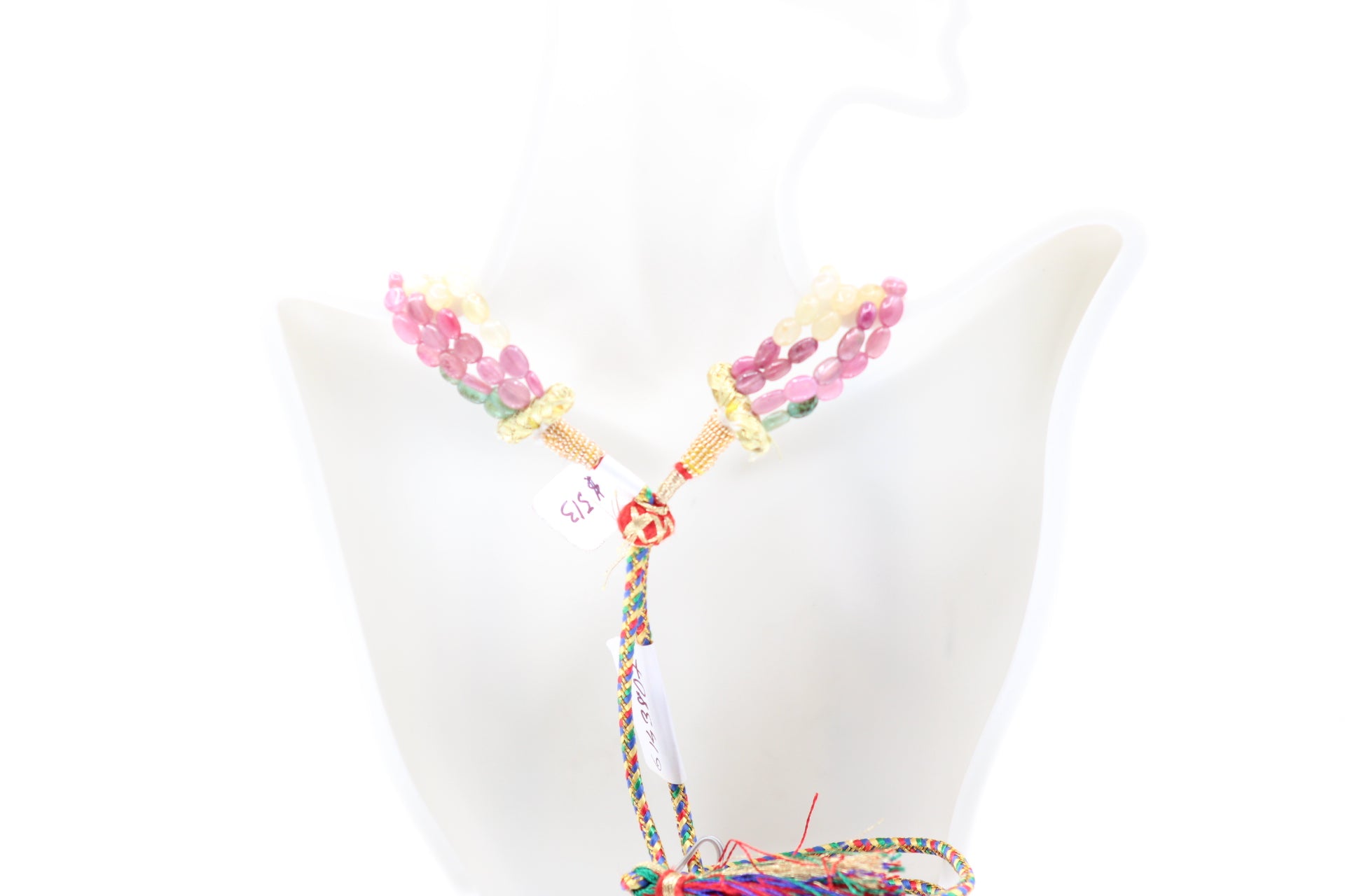 Multi Color Sapphire & Emerald Necklace displayed on a mannequin showcasing its vibrant colors and design.
