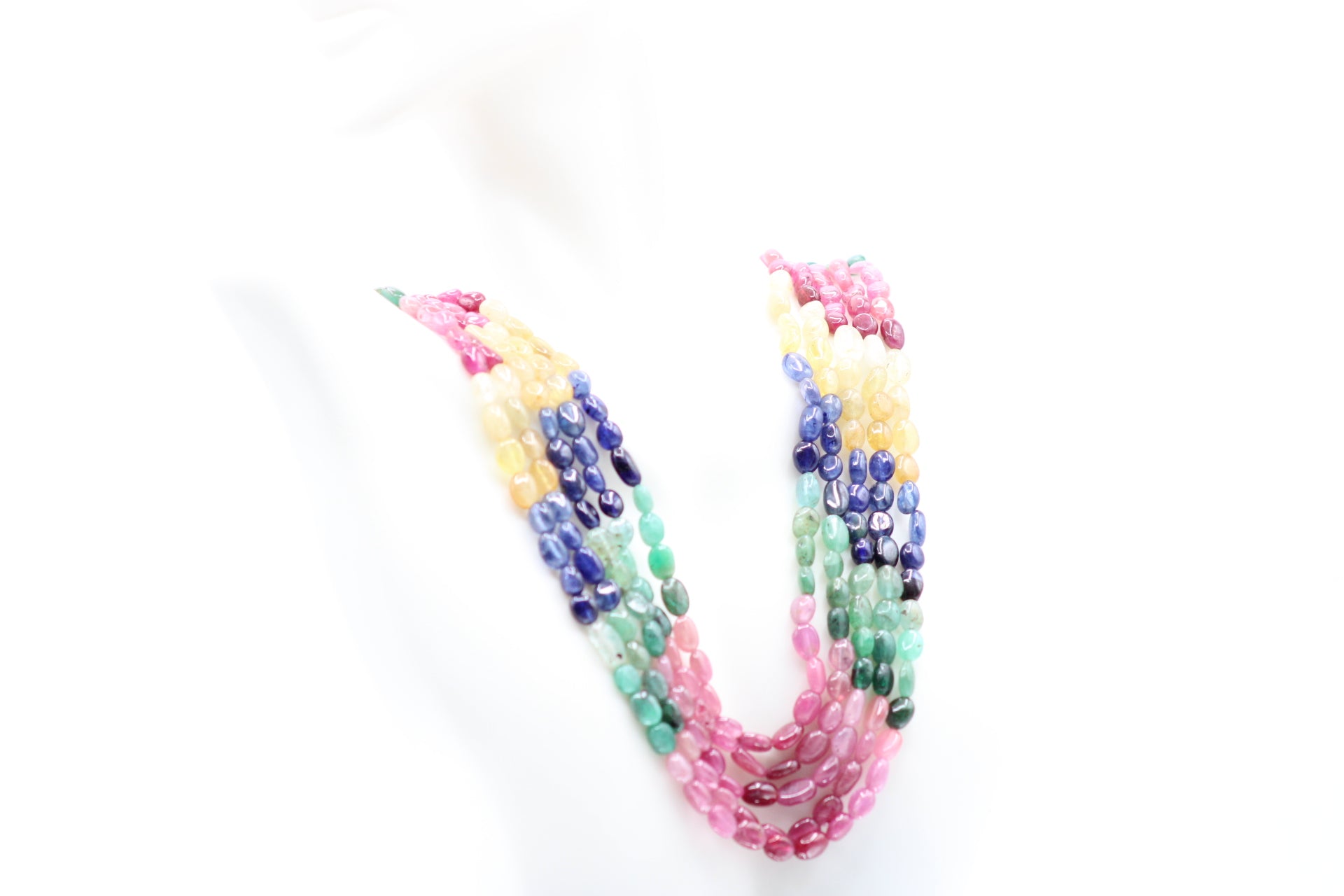 Multi Color Sapphire & Emerald Necklace displayed on a white background showcasing vibrant colored gemstones.