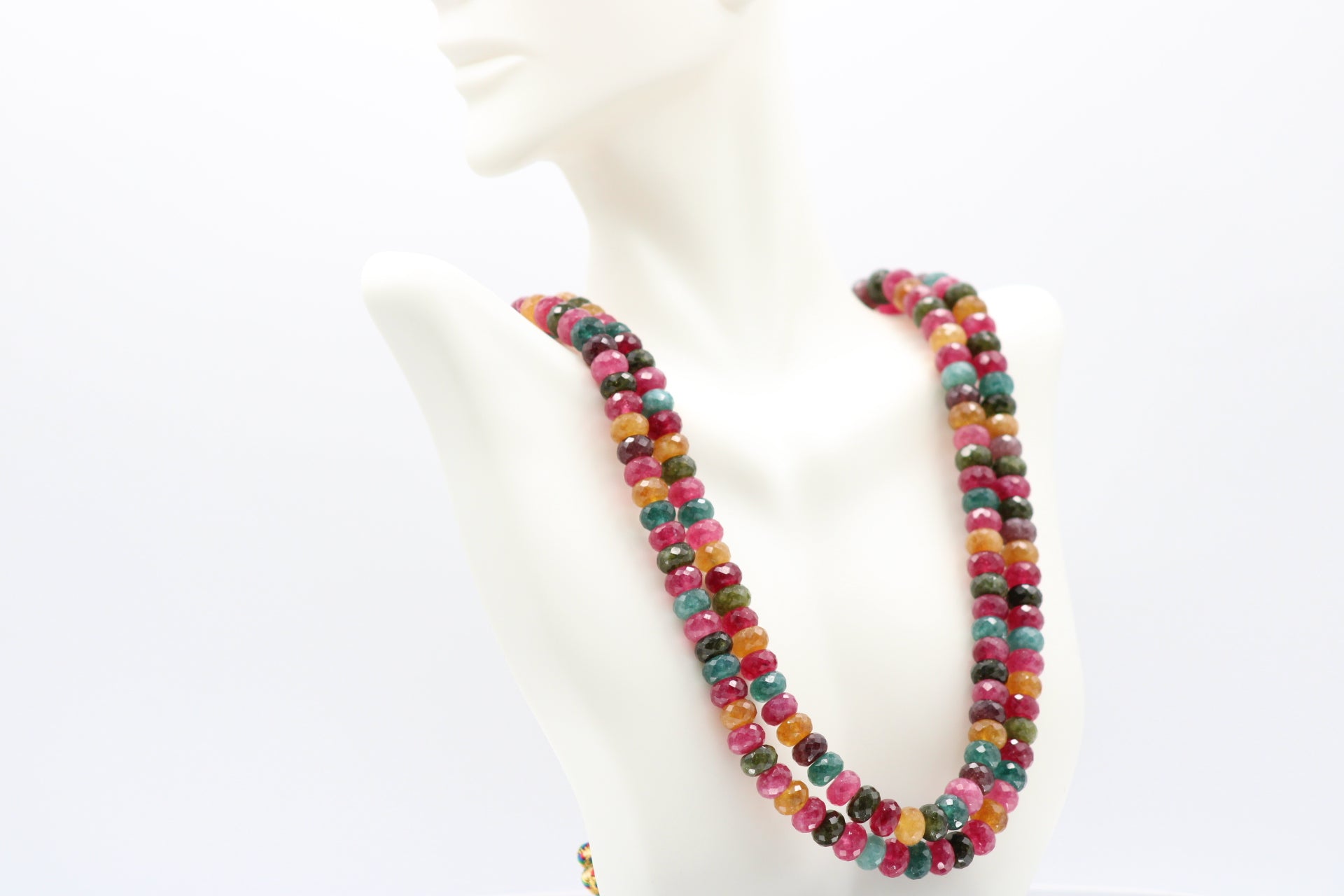 Multi-Color Jade Faceted Necklace showcasing vibrant gemstones in various hues on a display bust.