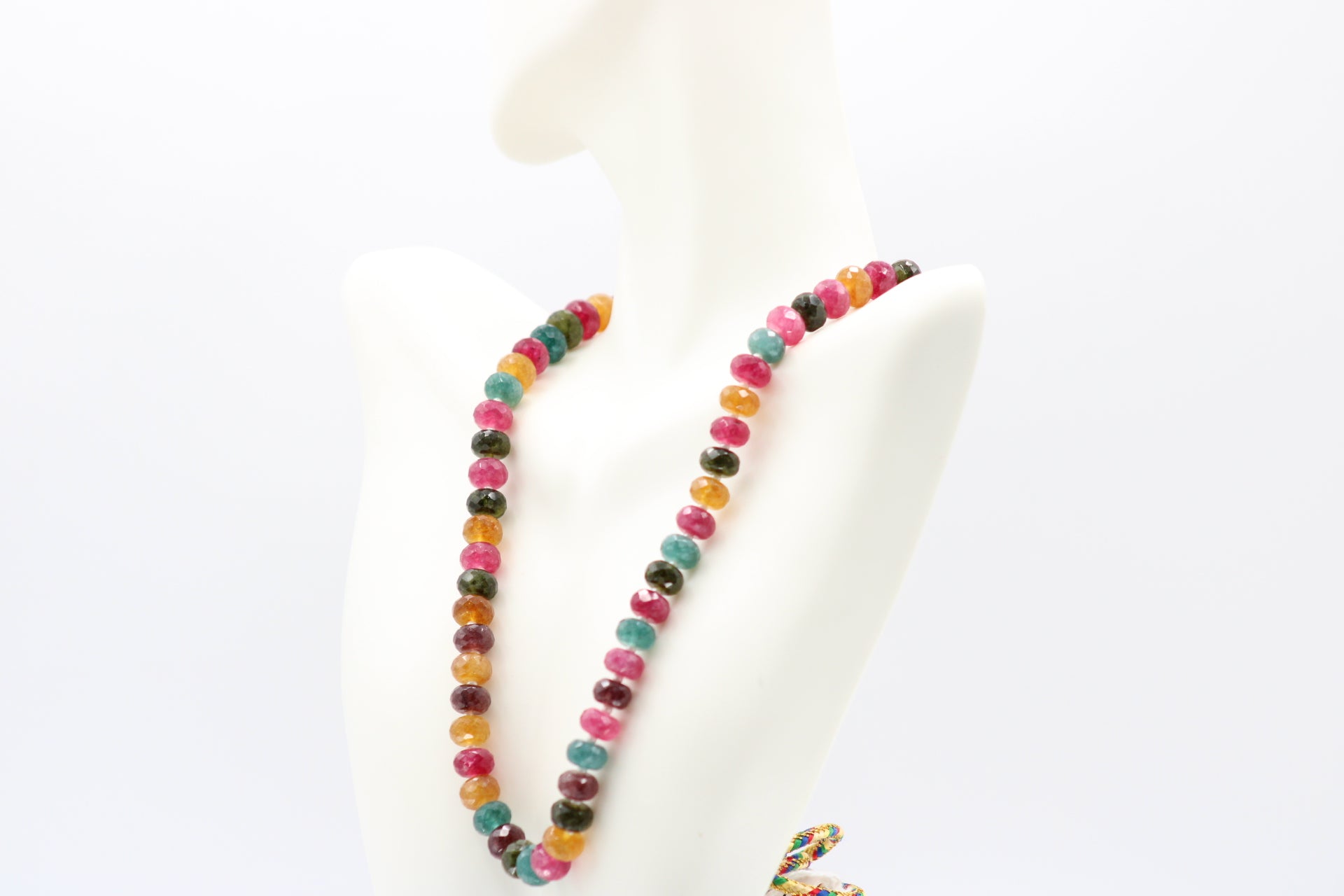 Multi Color Jade & Pearl Necklace displayed on a mannequin with vibrant gemstones in various colors.