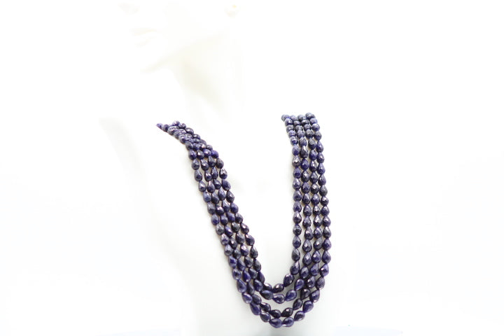The Blue Sapphire Briolette Pearl Shaped Necklace displayed on a mannequin, showcasing elegance and royal appeal.