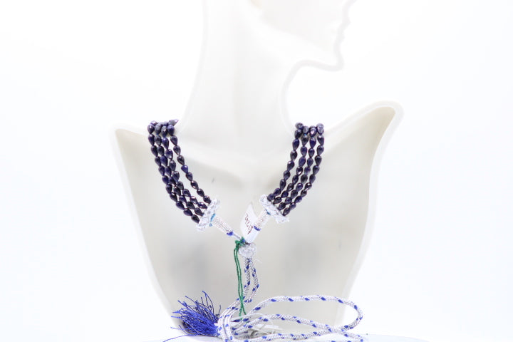 The Blue Sapphire Briolette Pearl Shaped Necklace displayed on a mannequin, showcasing its elegant design and rich color.