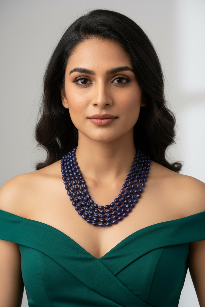 The Blue Sapphire Briolette Pearl Shaped Necklace worn elegantly by a model with long hair.