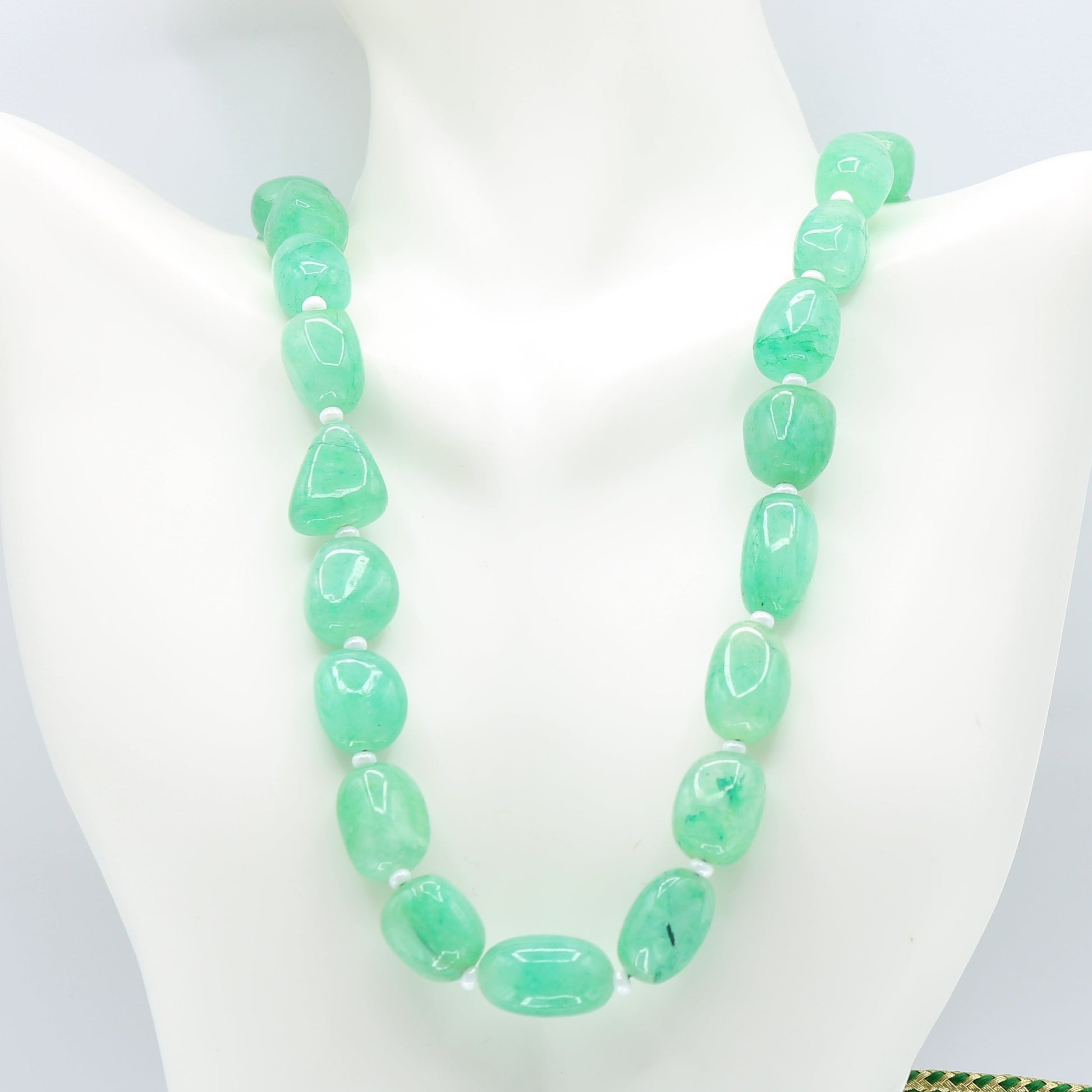 Emerald necklace featuring natural bluisg green emerald nuggets and cultured pearl accents.