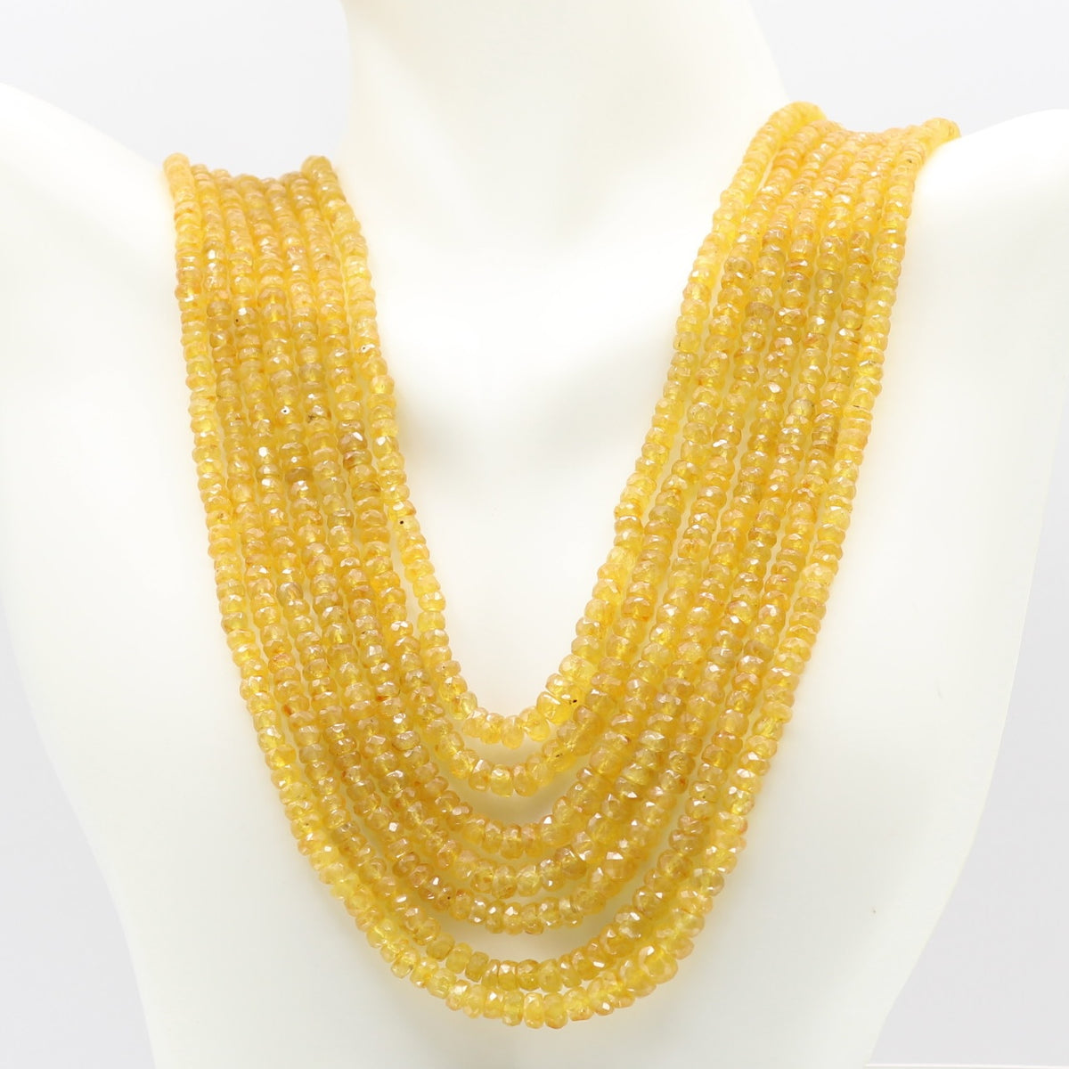 Yellow Sapphire faceted necklace showcasing multiple strands of natural yellow sapphires on a display.