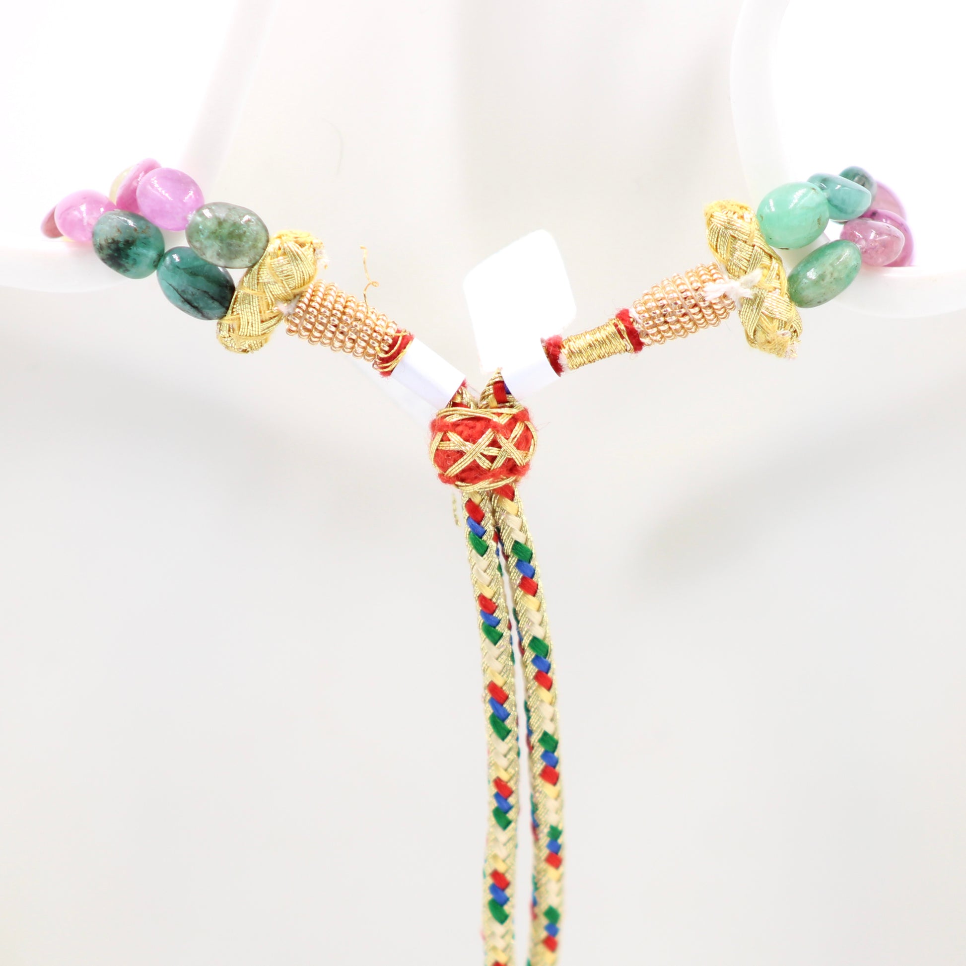 Multi Color Sapphire & Emerald Necklace displayed on a mannequin, featuring vibrant gemstones and intricate gold accents.