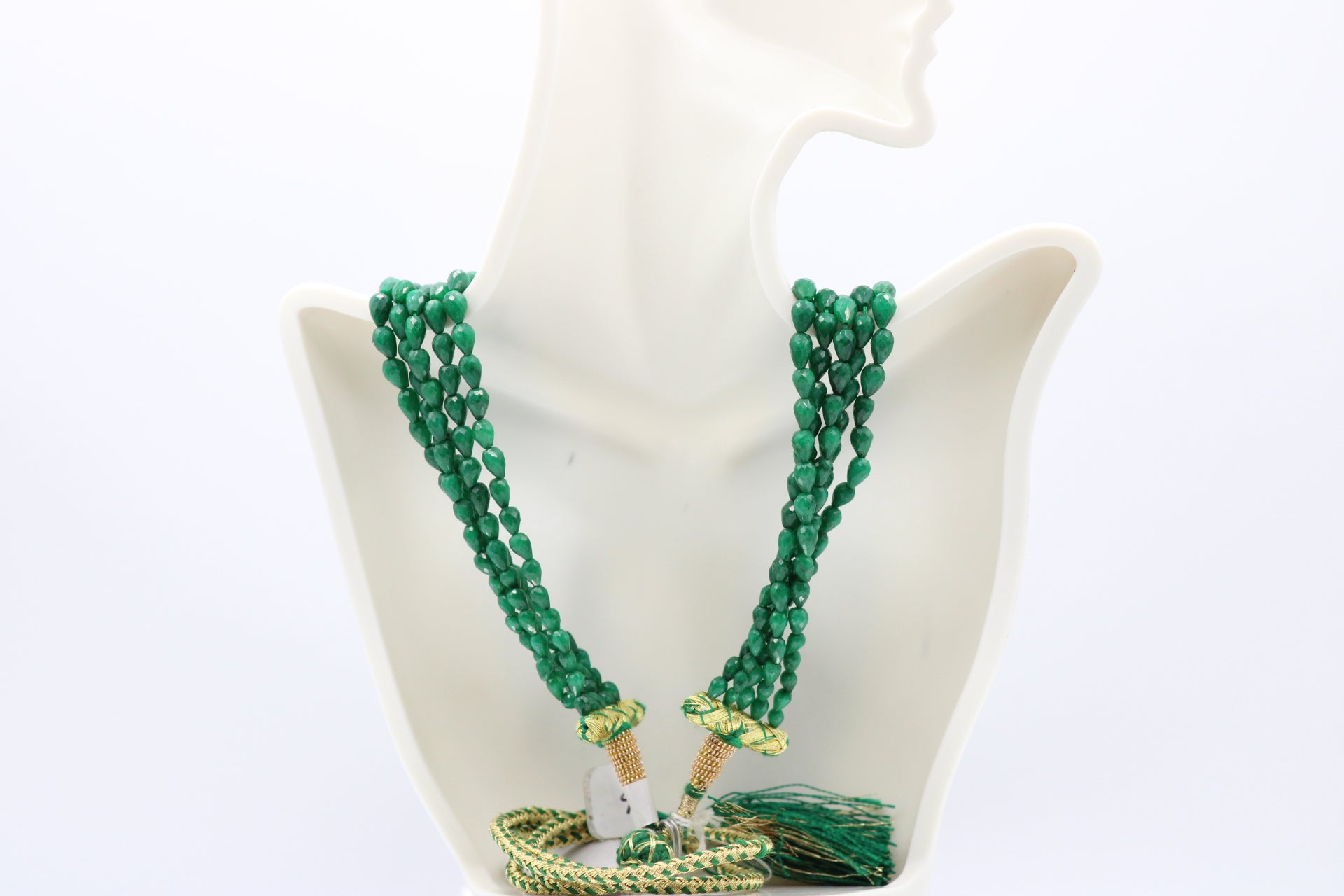 The Dark Green Sapphire Briolette Pearl Shaped Necklace displayed on a mannequin showcasing its elegance and artistry.