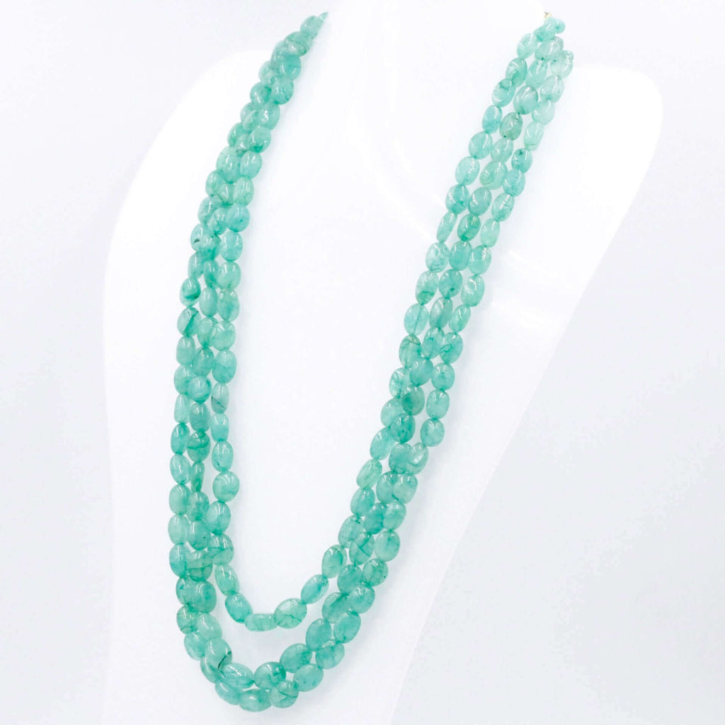 Layered necklace with multiple strands of Emerald beads