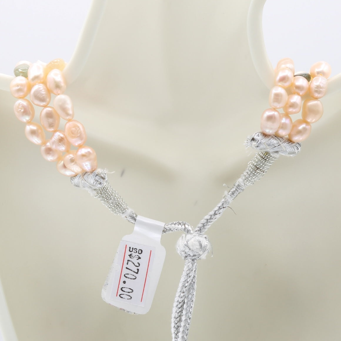 Pearl with Navratna layered necklace showcasing fresh water pearls on a mannequin's neck.