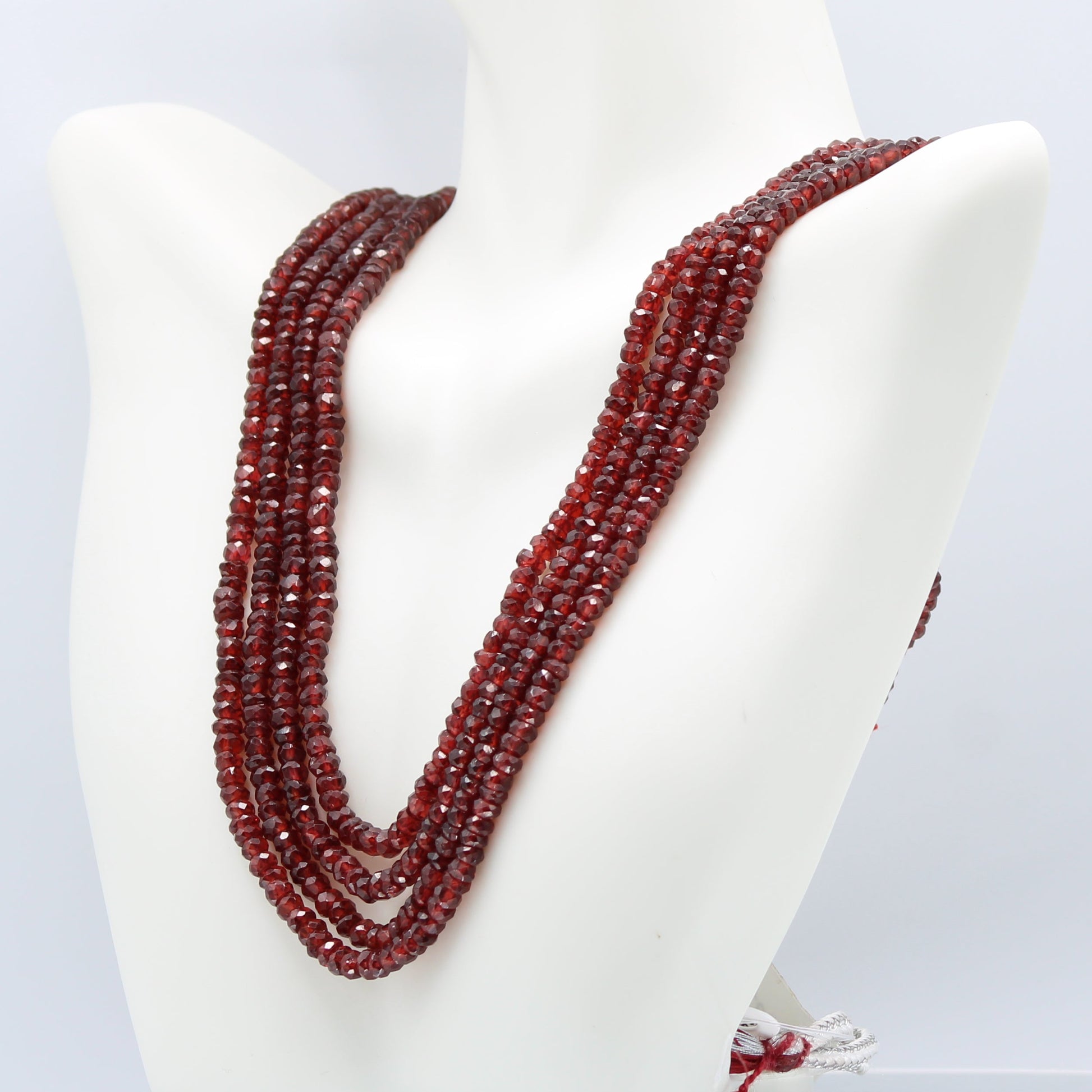 Rhodolite Garnet Beaded Necklace - 4 Strand showcasing vibrant rose red and pale violet beads on a display.
